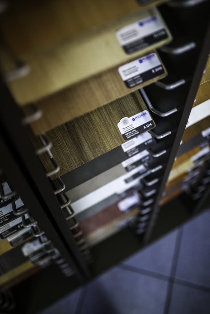 Close-up of various laminated wood veneer samples in a showroom display rack.